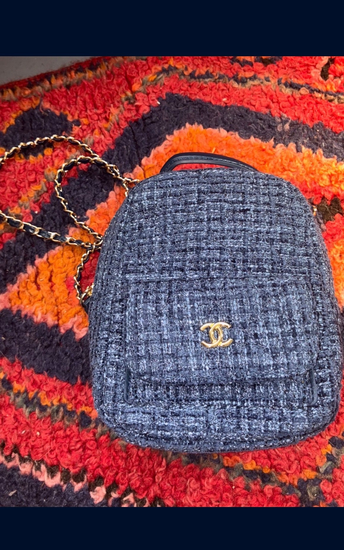 CHANEL backpack in navy tweed material with a quilted design.