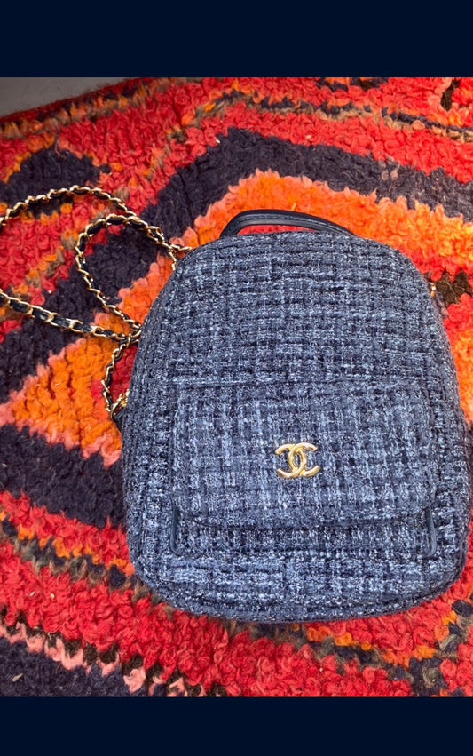 CHANEL backpack in navy tweed material with a quilted design.