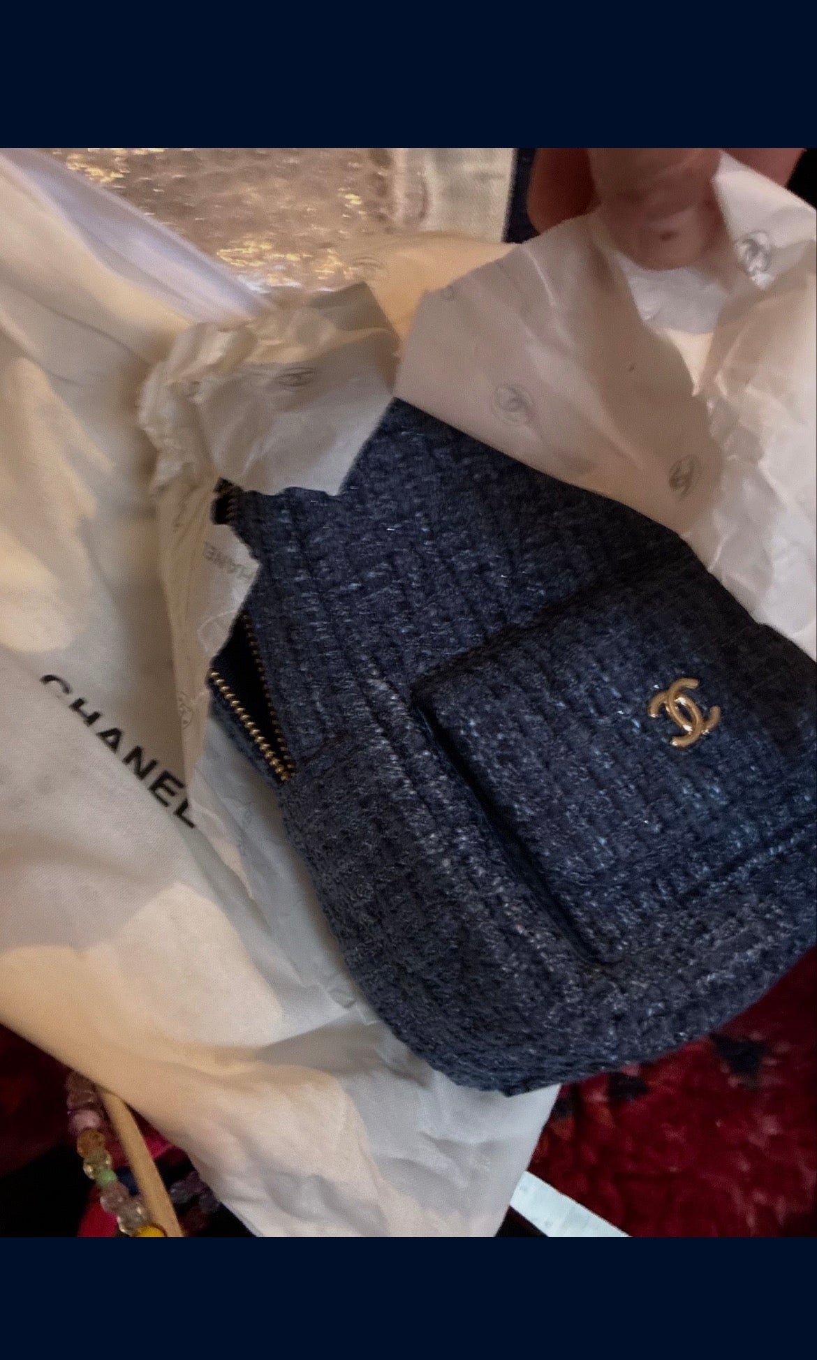 CHANEL backpack in navy tweed material with a quilted design.