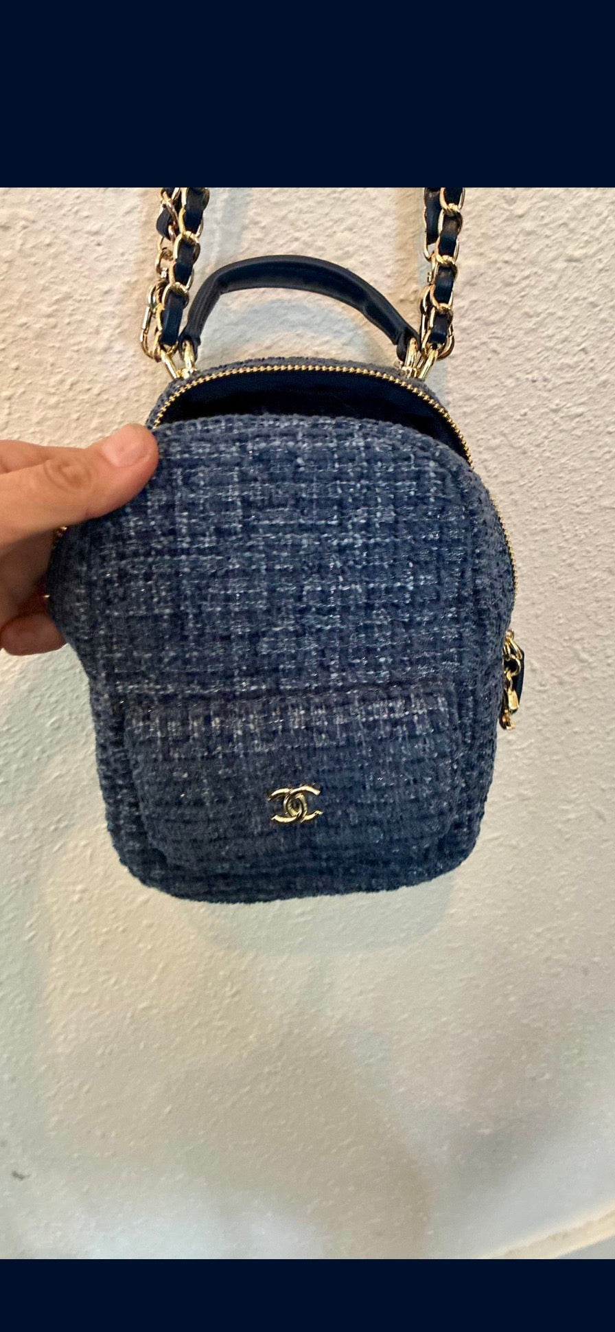 CHANEL backpack in navy tweed material with a quilted design.
