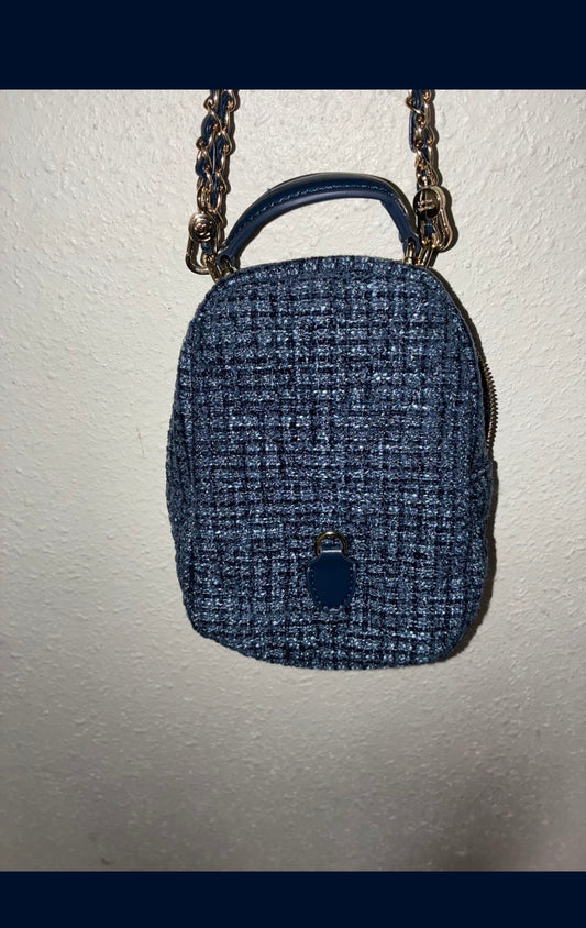 CHANEL backpack in navy tweed material with a quilted design.