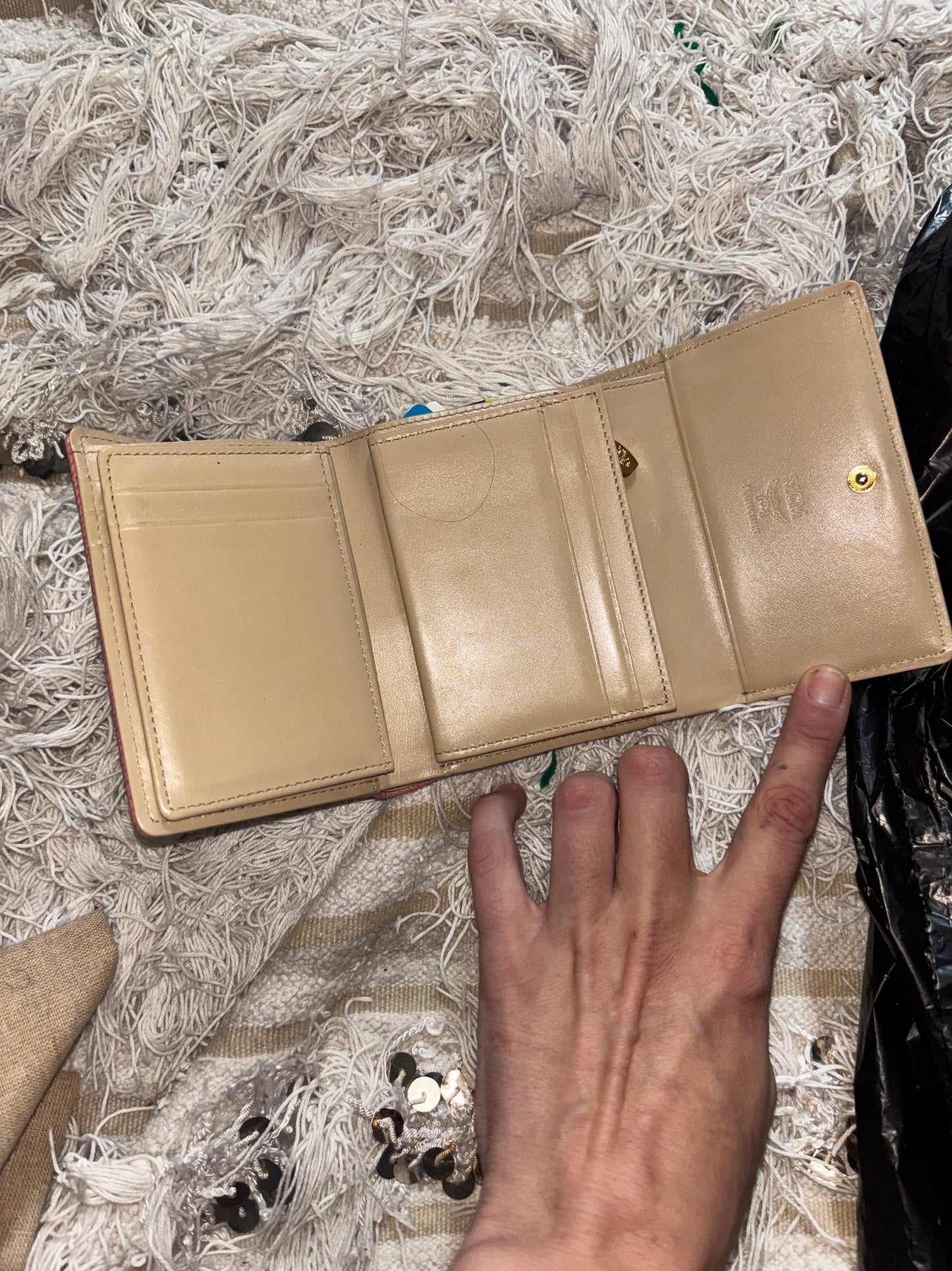 MCM wallet featuring a tri-color design with pink, beige, and green accents. It includes multiple card slots and a coin compartment, perfect for organizing essentials.