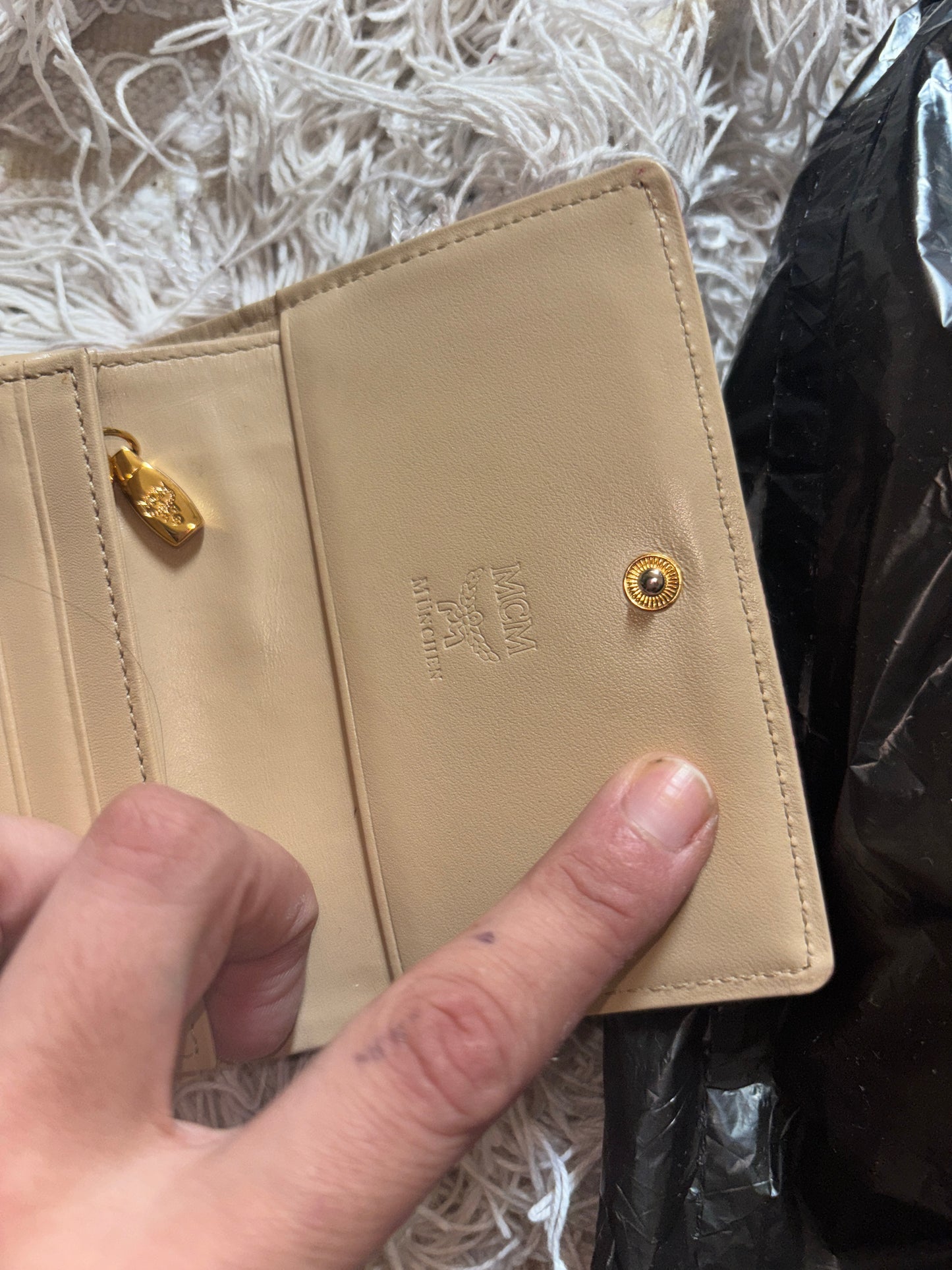MCM wallet featuring a tri-color design with pink, beige, and green accents. It includes multiple card slots and a coin compartment, perfect for organizing essentials.