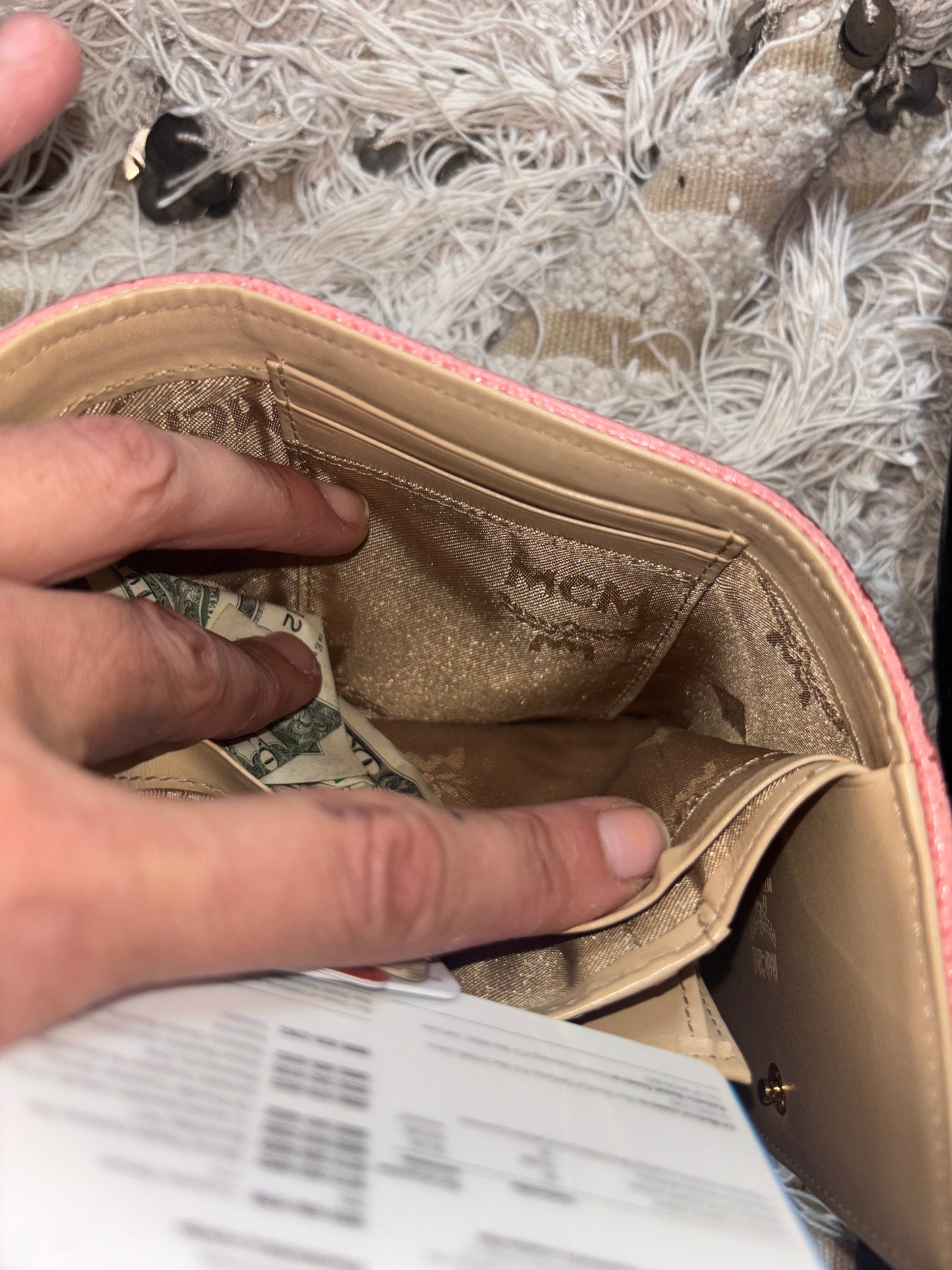 MCM wallet featuring a tri-color design with pink, beige, and green accents. It includes multiple card slots and a coin compartment, perfect for organizing essentials.