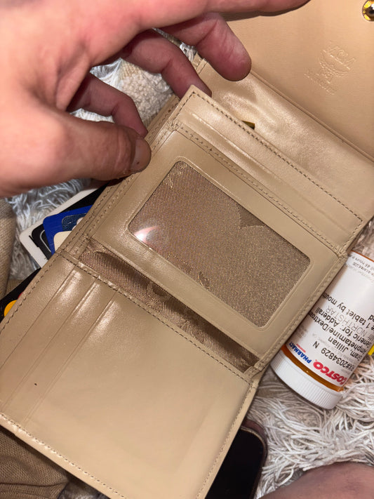 MCM wallet featuring a tri-color design with pink, beige, and green accents. It includes multiple card slots and a coin compartment, perfect for organizing essentials.